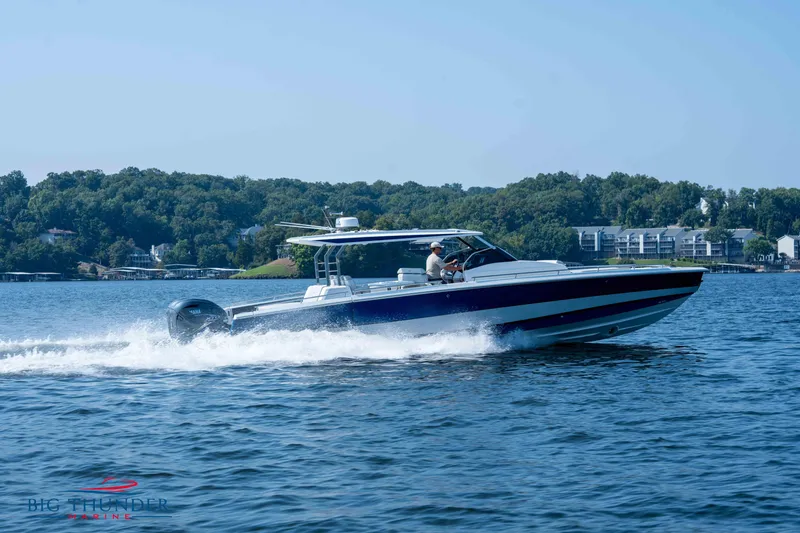 Slide: The Image of 2024 Opus 12 motorboat cruising on a lake. - 11