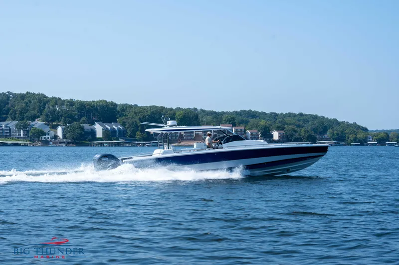 Slide: The Image of 2024 Opus 12 boat cruising on a lake under sunny skies. - 14