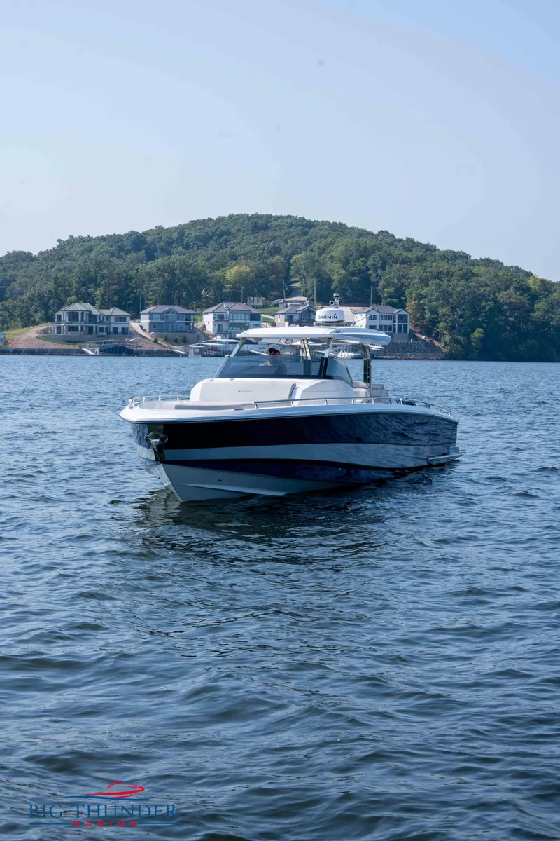 Slide: The Image of Opus 12 boat 2024 on calm water near wooded island. - 16