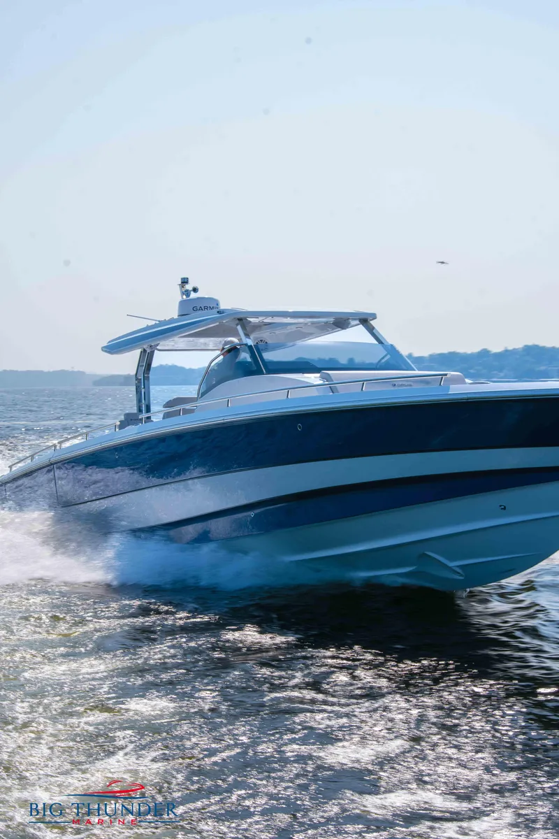 Slide: The Image of 2024 Opus 12 motorboat cruising swiftly on water. - 17