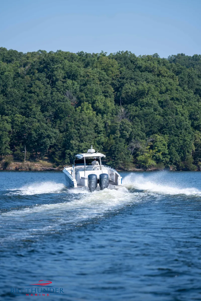 Slide: The Image of Opus 12 boat 2024 on a lake with forested background. - 18