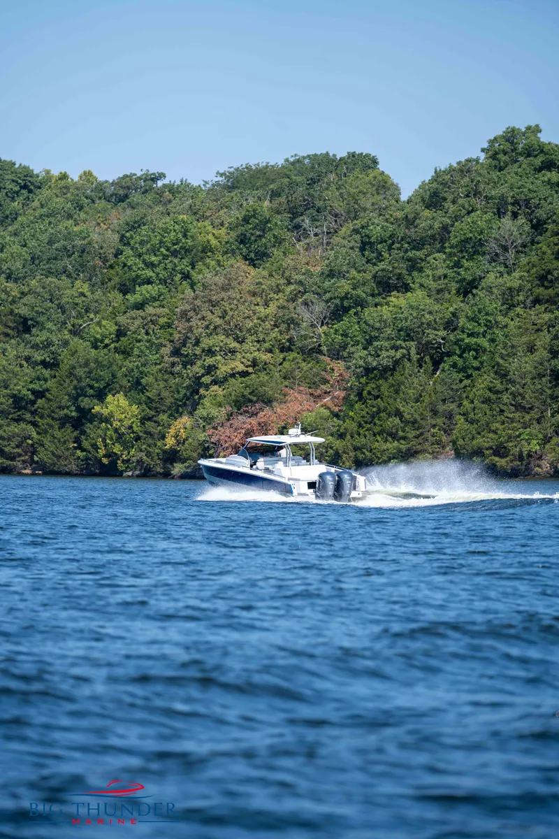 Slide: The Image of Opus 12 boat 2024 on a lake with forested background. - 19