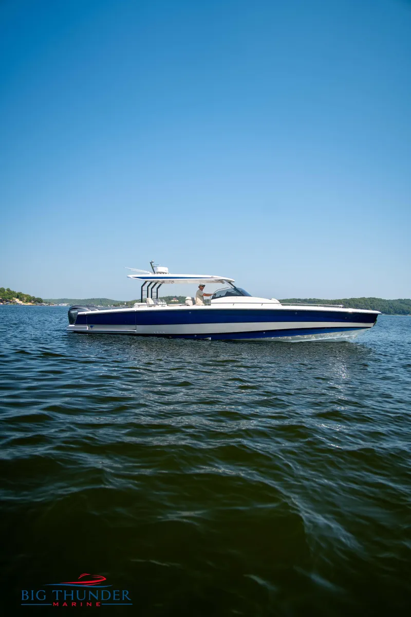 Slide: The Image of Opus 12 boat 2024 on calm water under clear sky. - 22