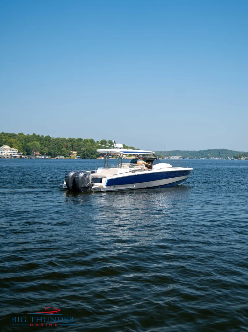 Slide: The Image of 2024 Opus 12 boat on a calm lake. - 24