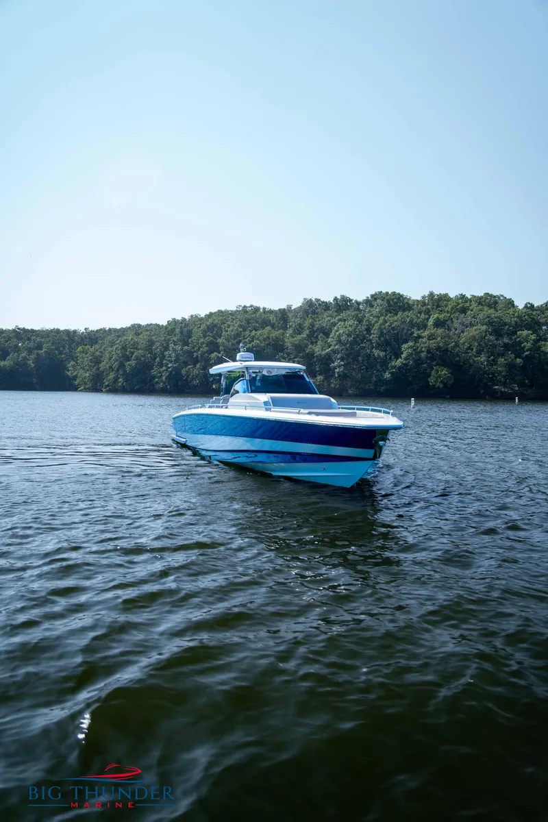 Slide: The Image of 2024 Opus 12 boat on a serene lake. - 26