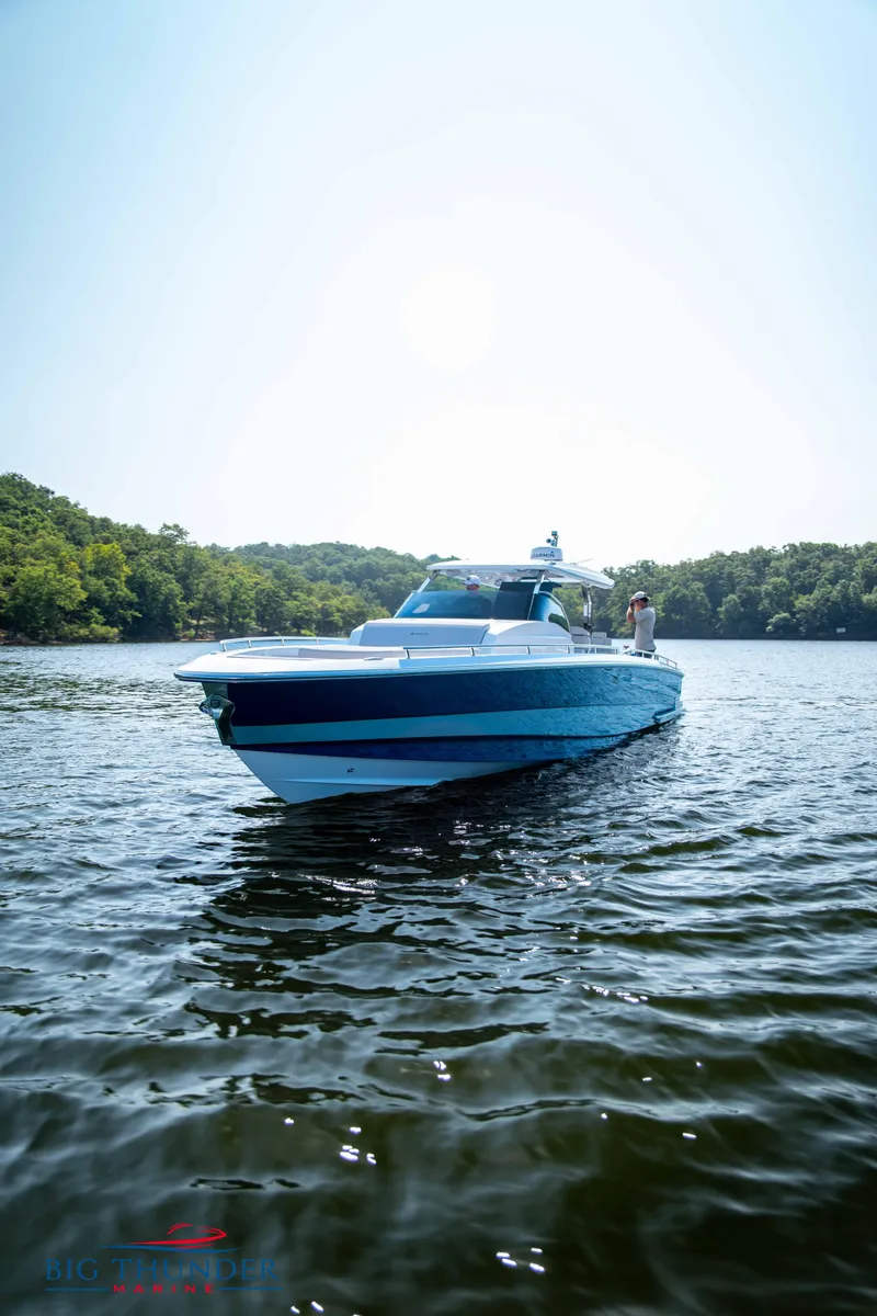 Slide: The Image of Opus 12 boat 2024 on calm water near green shoreline. - 27