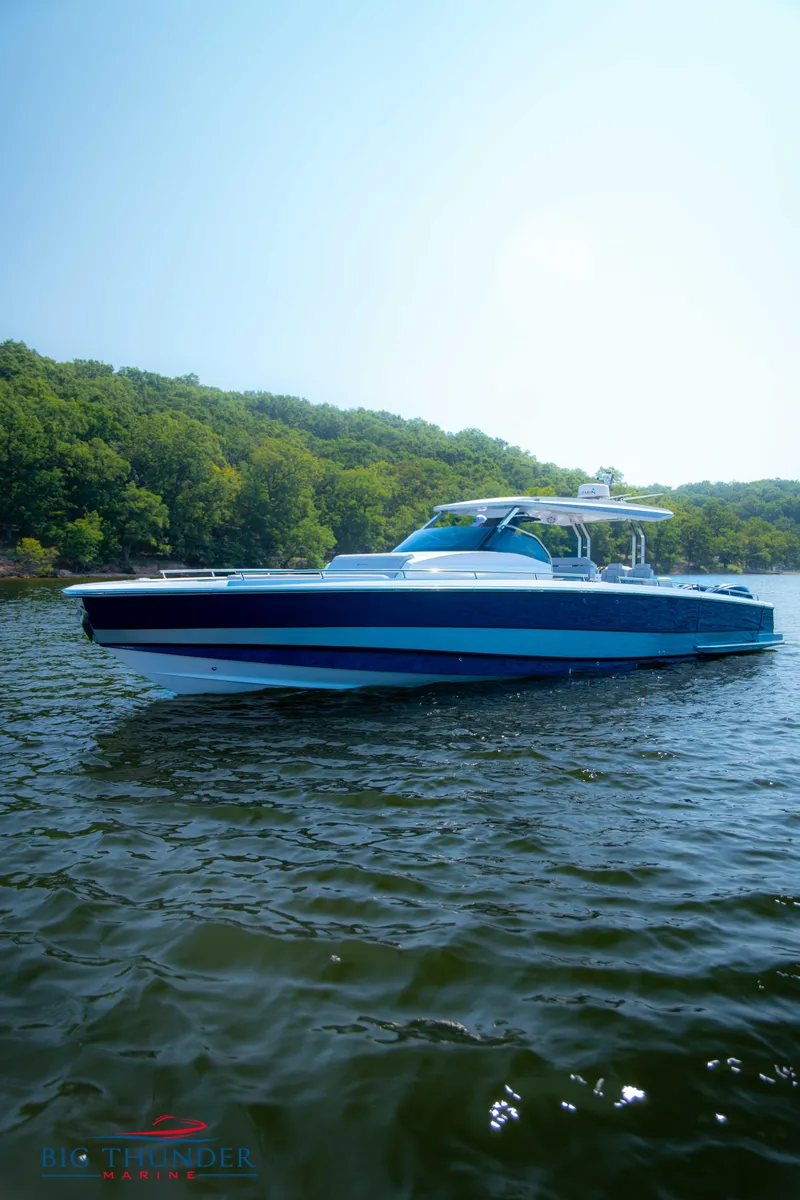 Slide: The Image of 2024 Opus 12 boat on a serene lake. - 28