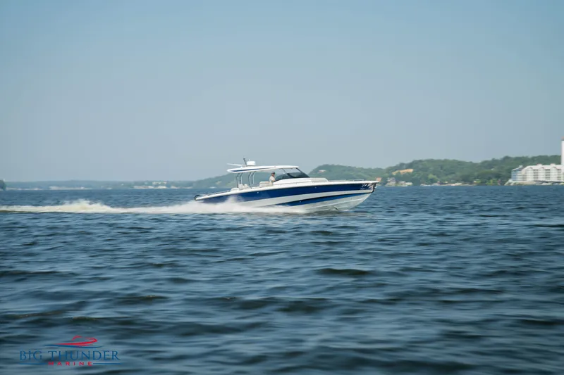 Slide: The Image of Opus 12 boat 2024 on water, blue and white design. - 3