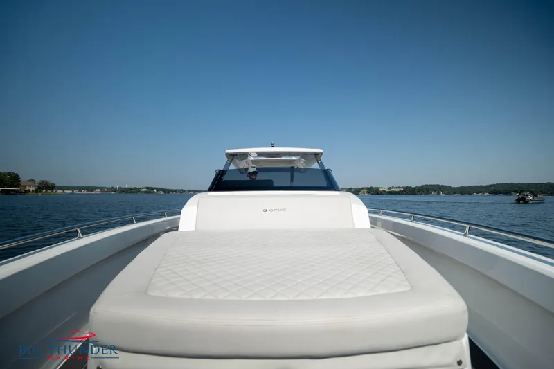 Slide: The Image of 2024 Opus 12 boat on calm water, front deck view. - 33