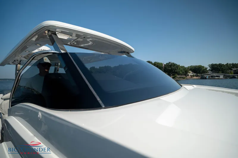 Slide: The Image of 2024 Opus 12 boat on calm water under sunny skies. - 37