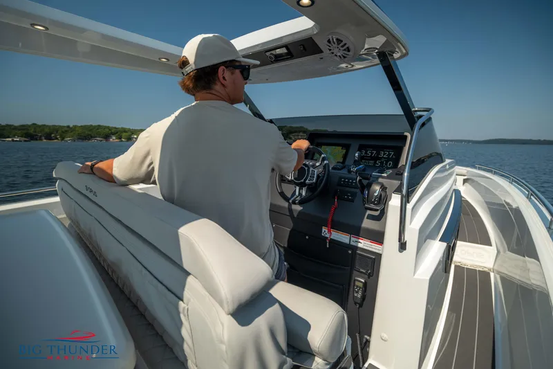 Slide: The Image of Man steering 2024 Opus 12 boat on open water. - 43