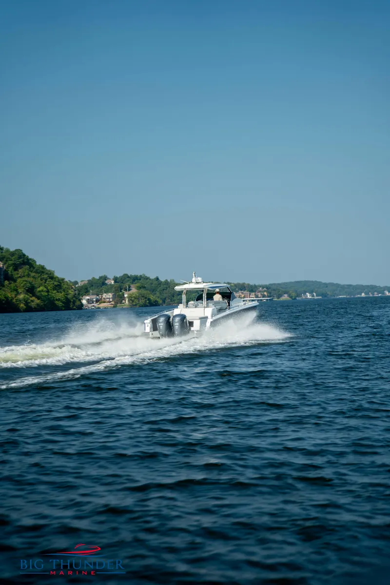 Slide: The Image of Opus 12 boat 2024 cruising on a lake under clear sky. - 7