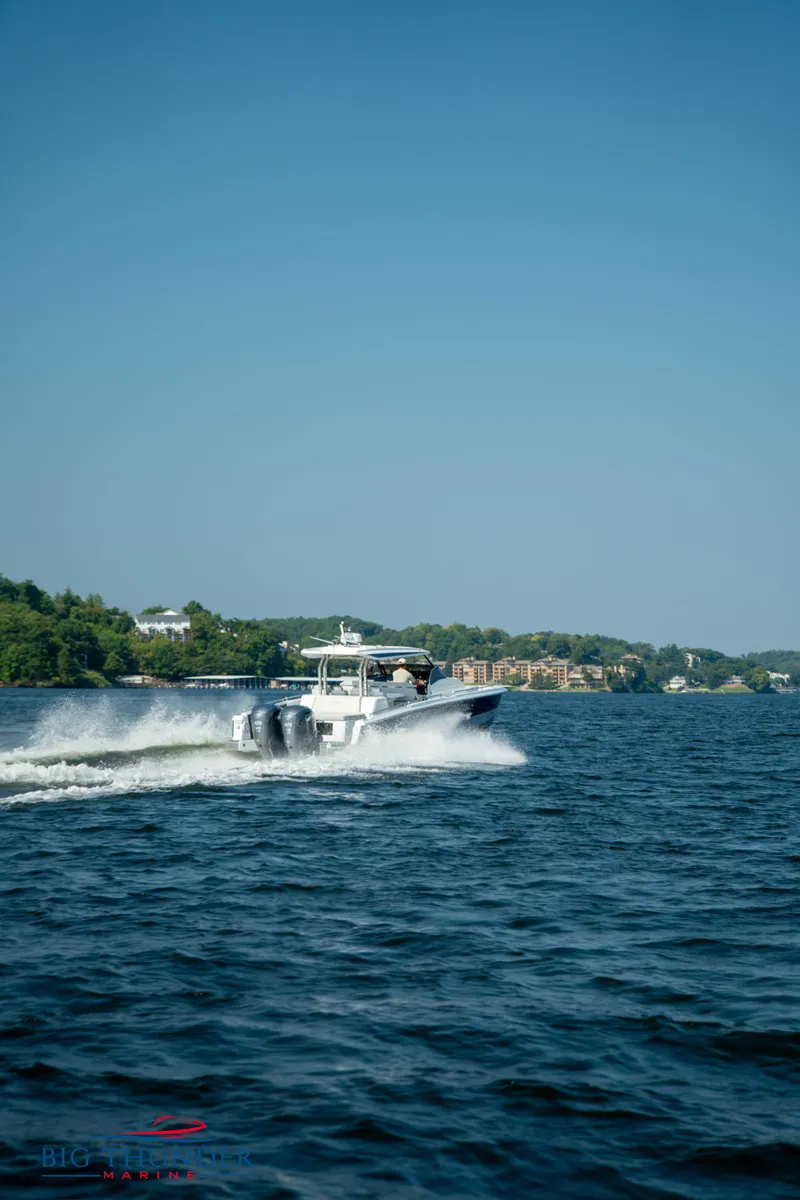 Slide: The Image of Opus 12 boat 2024 cruising on a lake under clear sky. - 8