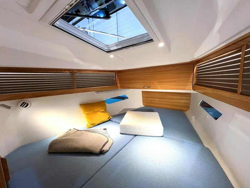 Slide: The Image of Cozy cabin interior of 2027 Dragonfly 36 sailboat with skylight and cushions. - 13