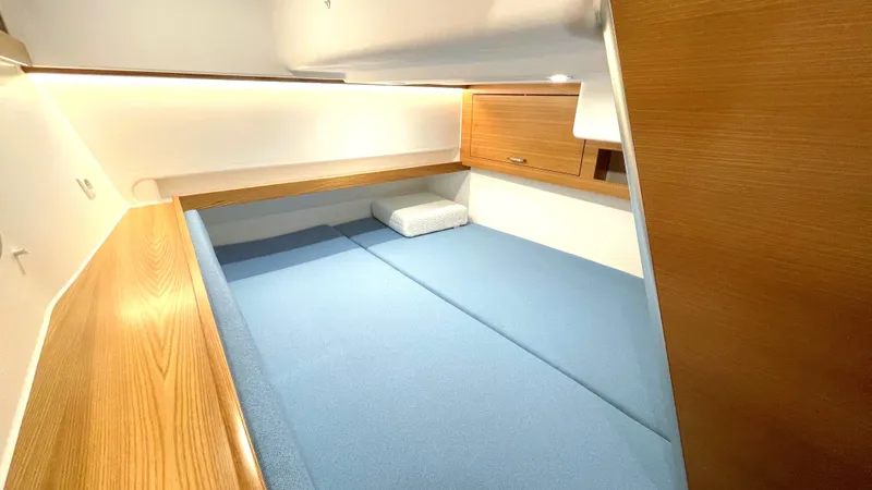 Slide: The Image of Cozy cabin interior of 2027 Dragonfly 36 with blue bedding and wooden accents. - 15