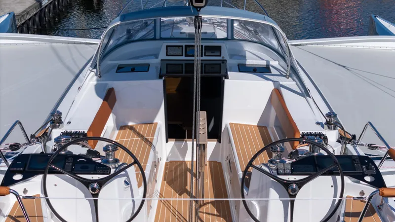 Slide: The Image of 2027 Dragonfly 36 yacht cockpit with dual steering wheels and modern navigation equipment. - 8