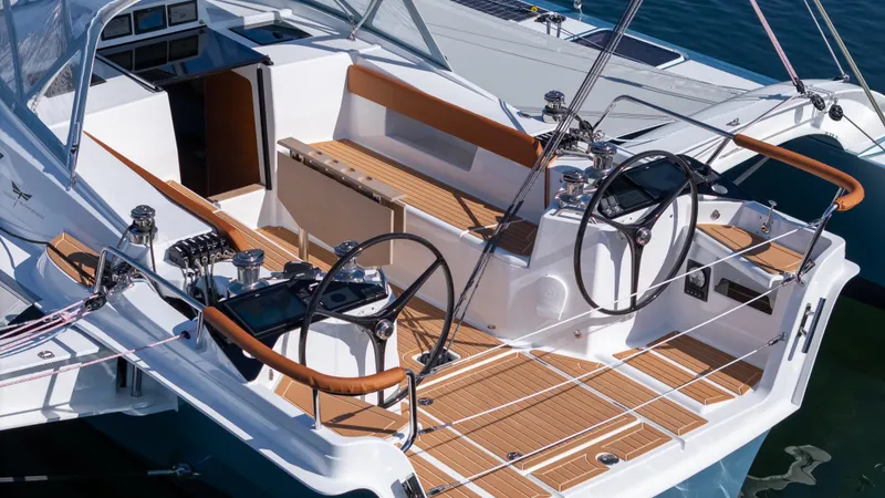 Slide: The Image of Modern Dragonfly 36 sailboat cockpit with dual steering wheels, teak decking, and sleek design, 2027 model. - 9