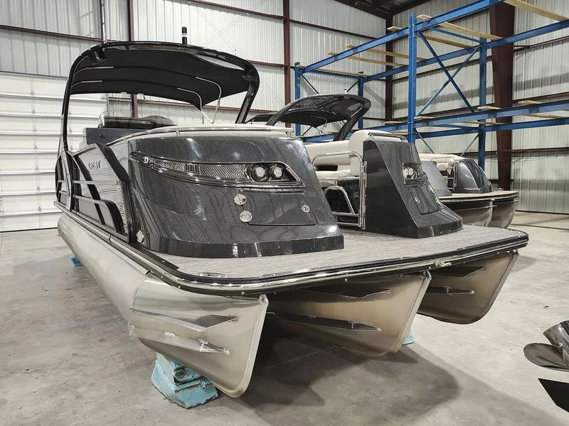 Slide: The Image of 2022 Crest 250SLS Savanna pontoon boat in warehouse, sleek design, black finish. - 10