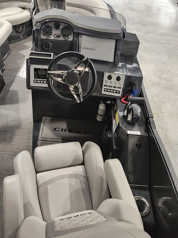 Slide: The Image of 2022 Crest 250SLS Savanna boat interior with steering wheel and control panel. - 11