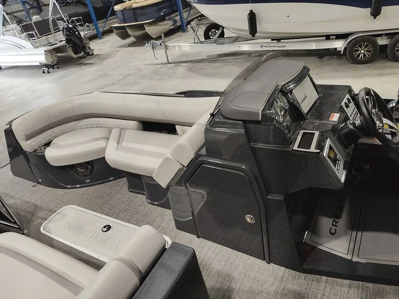 Slide: The Image of 2022 Crest 250SLS Savanna boat interior with sleek dashboard and comfortable seating. - 12
