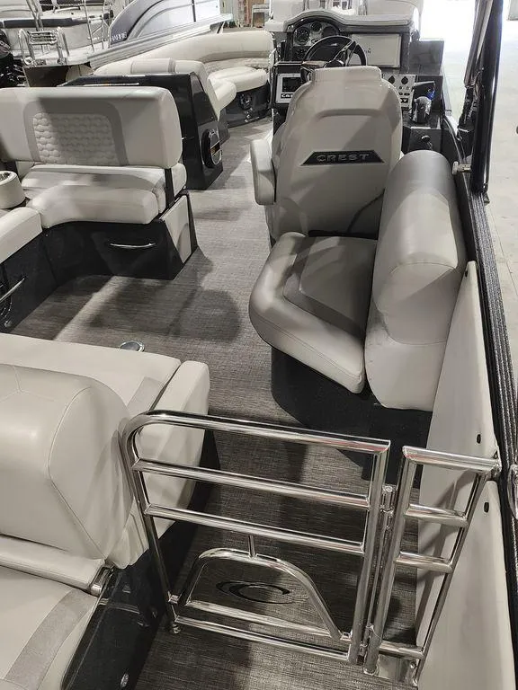 Slide: The Image of 2022 Crest 250SLS Savanna boat interior with plush seating and modern helm. - 13