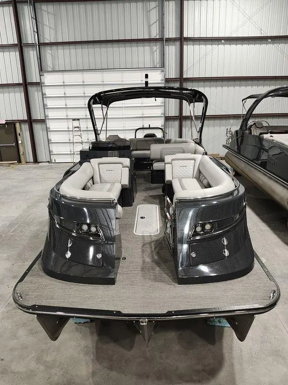 Slide: The Image of 2022 Crest 250SLS Savanna pontoon boat with sleek design in a warehouse setting. - 14