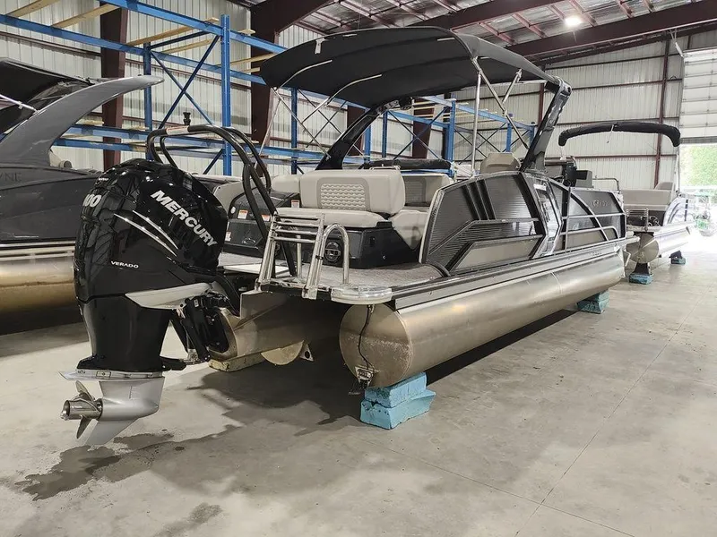 Slide: The Image of 2022 Crest 250SLS Savanna pontoon boat with Mercury engine in a warehouse setting. - 15