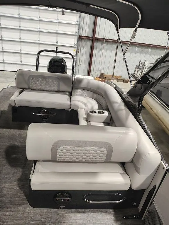 Slide: The Image of 2022 Crest 250SLS Savanna pontoon boat interior with plush seating and modern design. - 16