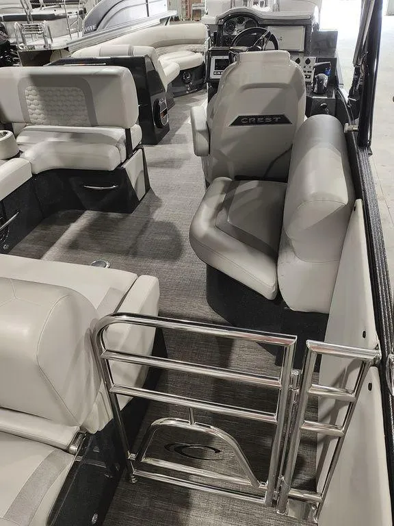 Slide: The Image of 2022 Crest 250SLS Savanna boat interior with plush seating and modern design. - 17