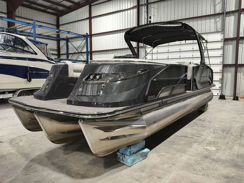 Slide: The Image of 2022 Crest 250SLS Savanna pontoon boat in a warehouse setting. - 18