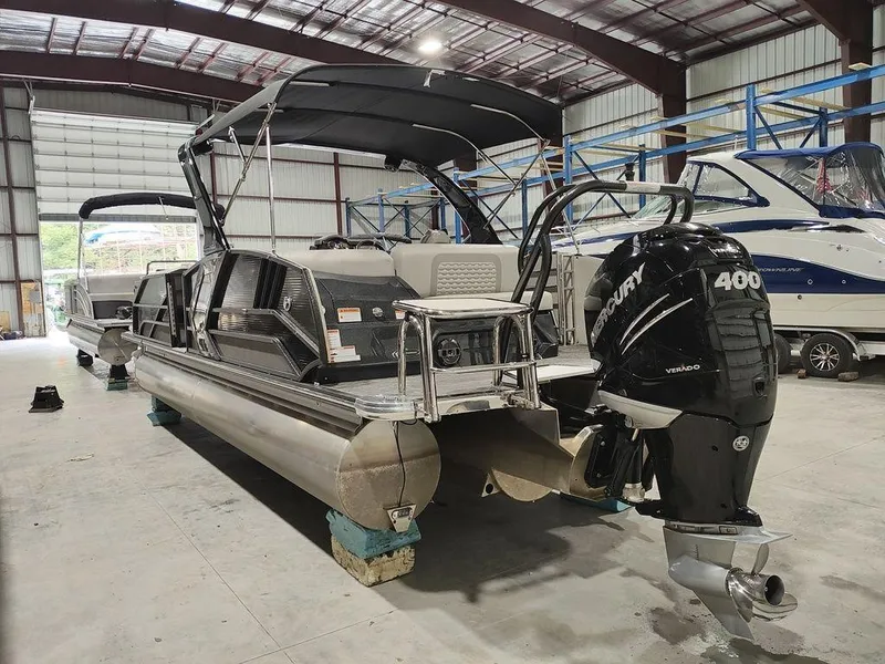 Slide: The Image of 2022 Crest 250SLS Savanna pontoon boat with Mercury 400 engine in a storage facility. - 19