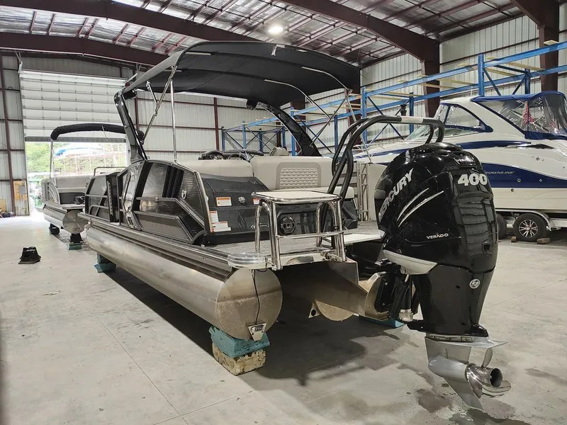 Slide: The Image of 2022 Crest 250SLS Savanna pontoon boat with Mercury 400 engine in a storage facility. - 7