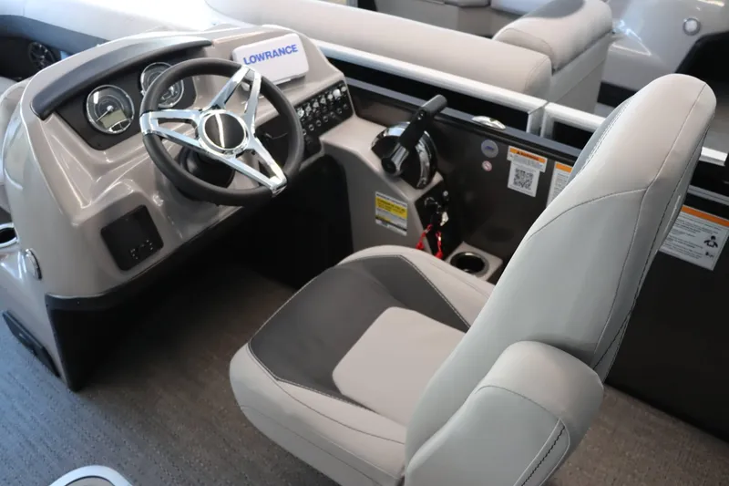 Slide: The Image of 2025 Barletta ARIA 22QC boat interior with steering wheel and captain's chair. - 5