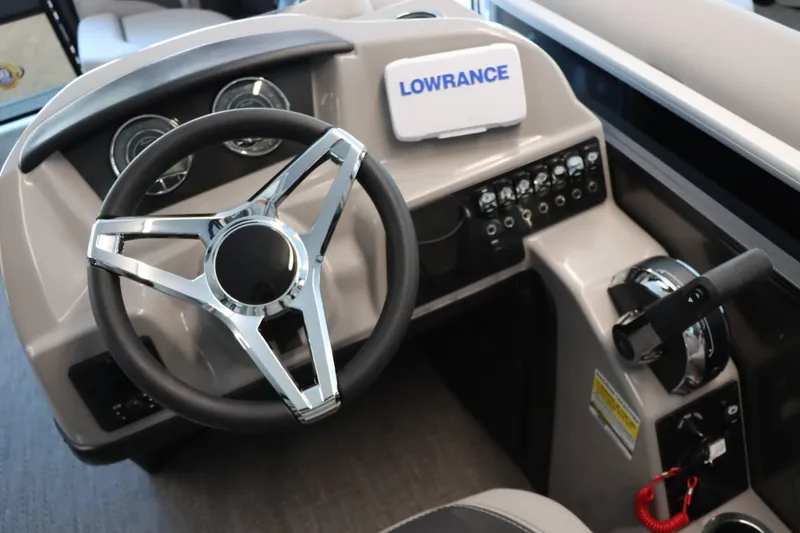 Slide: The Image of 2025 Barletta ARIA 22QC boat dashboard with steering wheel and control panel. - 6