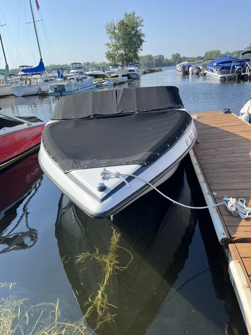 Slide: The Image of 2005 Crownline 180 BR boat docked in a marina, covered and secured. - 1