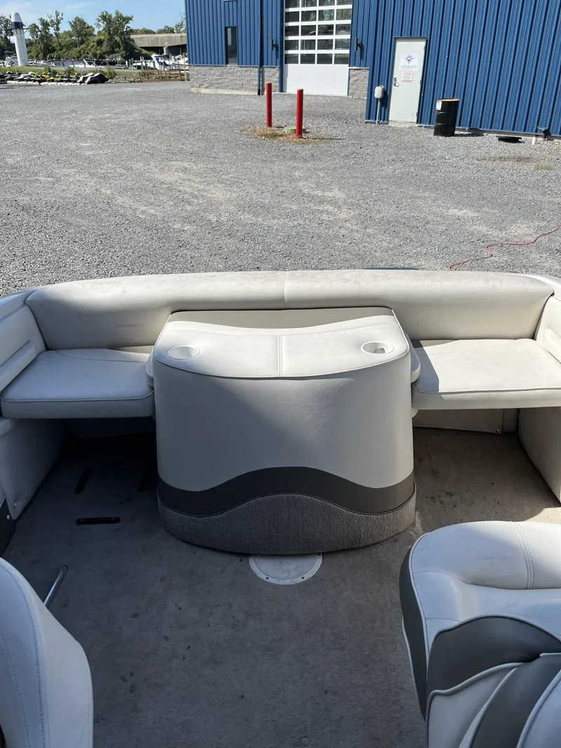 Slide: The Image of 2005 Crownline 180 BR boat interior with white seating and storage compartment. - 10