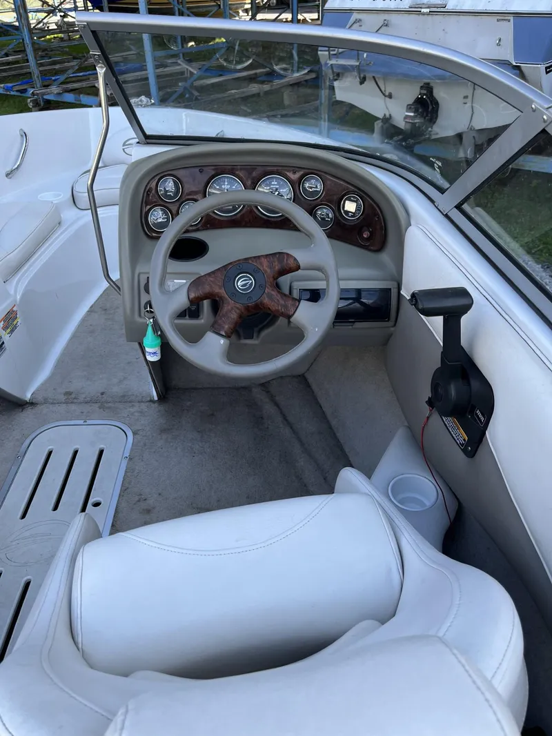 Slide: The Image of 2005 Crownline 180 BR boat interior with steering wheel and dashboard controls. - 13