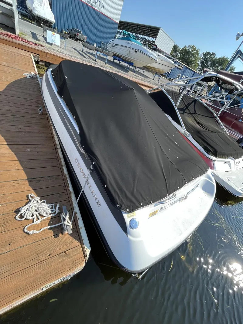 Slide: The Image of 2005 Crownline 180 BR boat docked with black cover. - 2