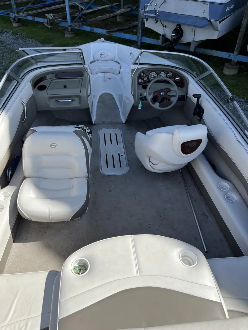 Slide: The Image of 2005 Crownline 180 BR boat interior with steering wheel and seating. - 7
