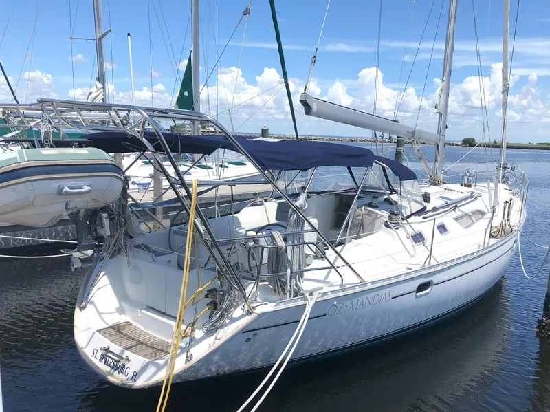 The Image of 2001 Jeanneau 45.2 sailboat docked in marina under clear blue sky. - 0