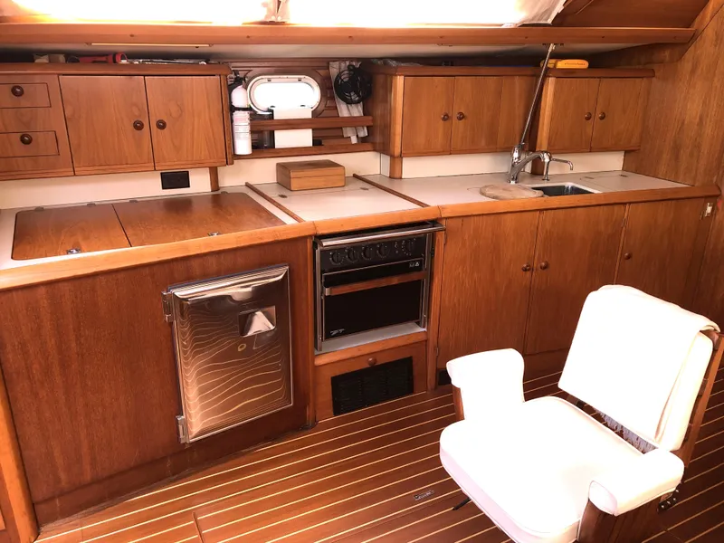 Slide: The Image of Interior of 2001 Jeanneau 45.2 yacht kitchen with wooden cabinets and appliances. - 10