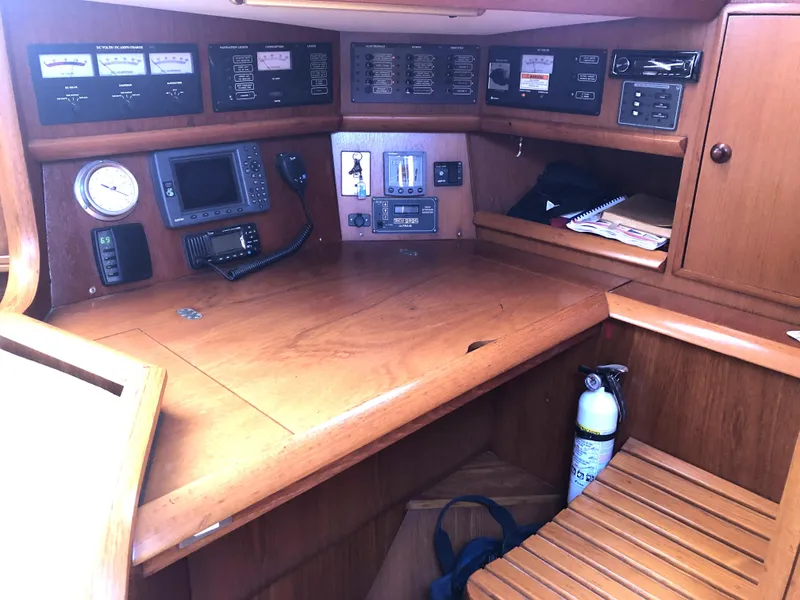 Slide: The Image of Navigation station of a 2001 Jeanneau 45.2 sailboat with control panels and equipment. - 11
