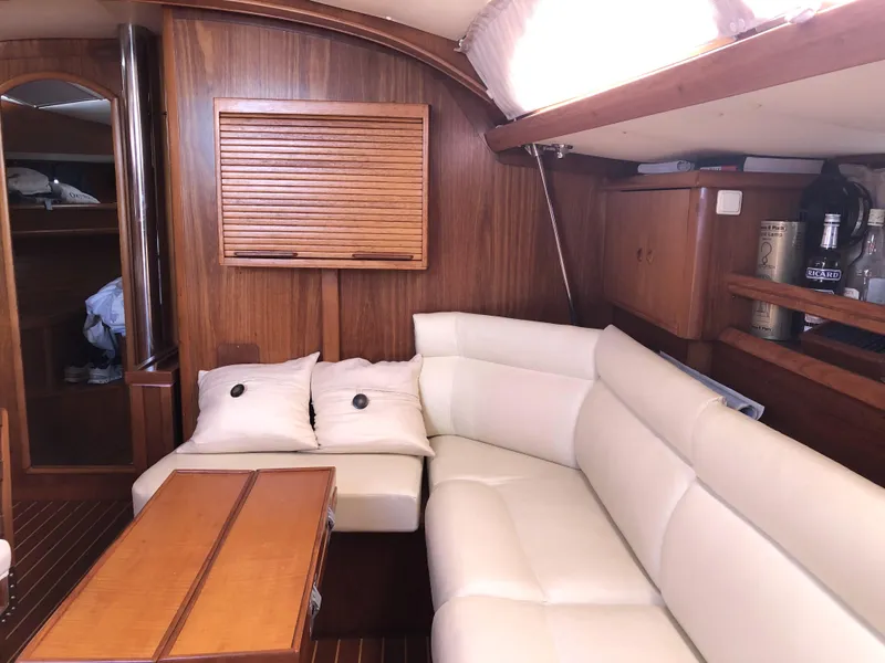 Slide: The Image of Interior of 2001 Jeanneau 45.2 yacht with white leather seating and wooden accents. - 13