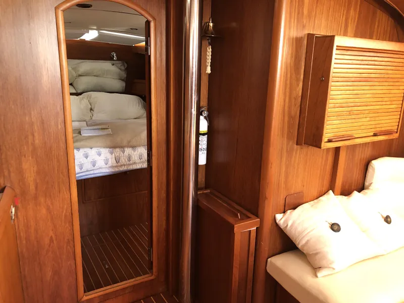 Slide: The Image of Interior of 2001 Jeanneau 45.2 yacht with wooden finish and cozy bedding. - 14