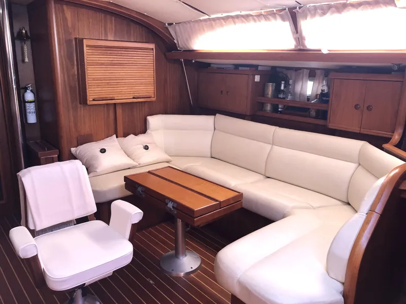 Slide: The Image of Luxurious interior of 2001 Jeanneau 45.2 yacht with white leather seating and wooden accents. - 15