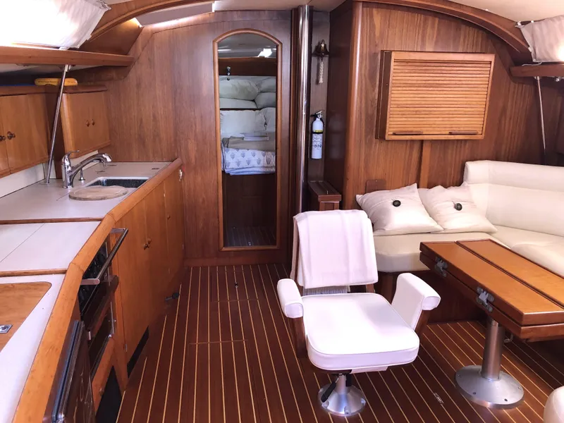 Slide: The Image of Interior of 2001 Jeanneau 45.2 yacht with wood finish and comfortable seating. - 16