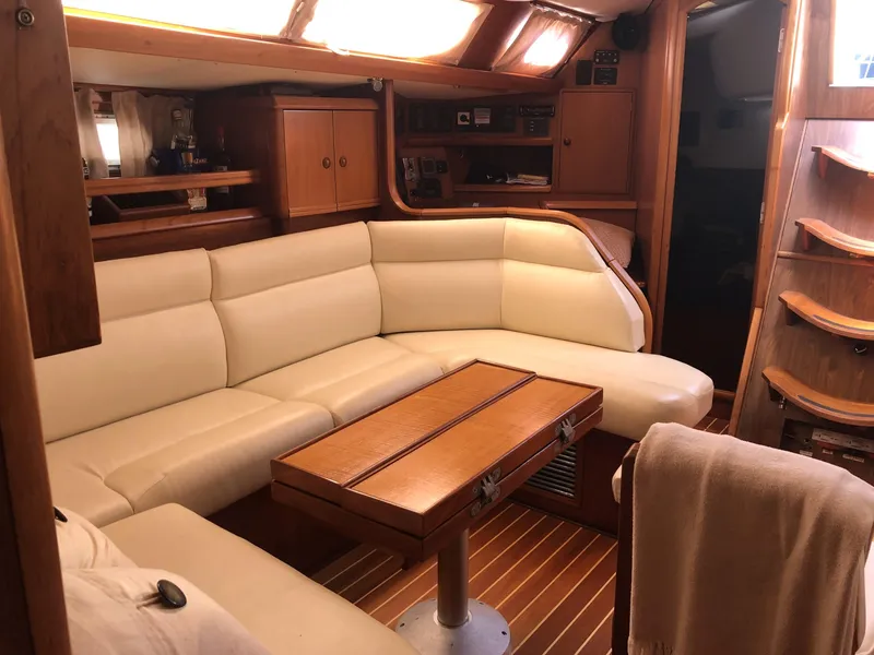 Slide: The Image of Luxurious interior of 2001 Jeanneau 45.2 yacht with cream leather seating and wooden accents. - 17