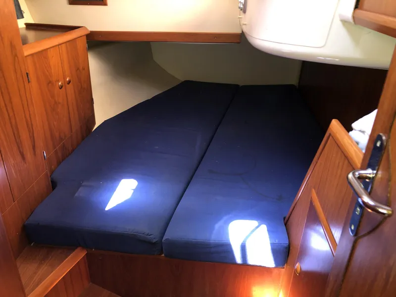 Slide: The Image of Cozy cabin interior of 2001 Jeanneau 45.2 sailboat with blue mattress. - 19