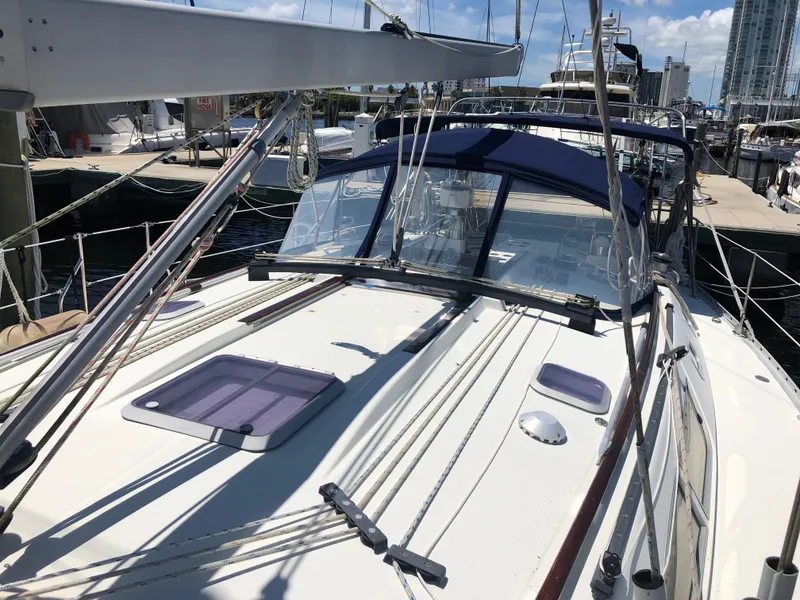 Slide: The Image of 2001 Jeanneau 45.2 sailboat docked at marina, featuring deck and rigging details. - 2
