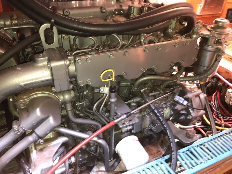 Slide: The Image of Engine of a 2001 Jeanneau 45.2 sailboat, showcasing mechanical components and wiring. - 20